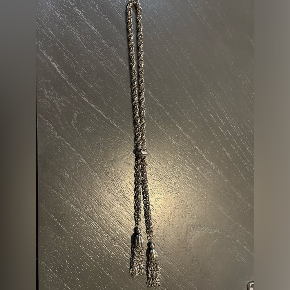 Silver slide necklace. Has a slider to designate how you will be styling it.